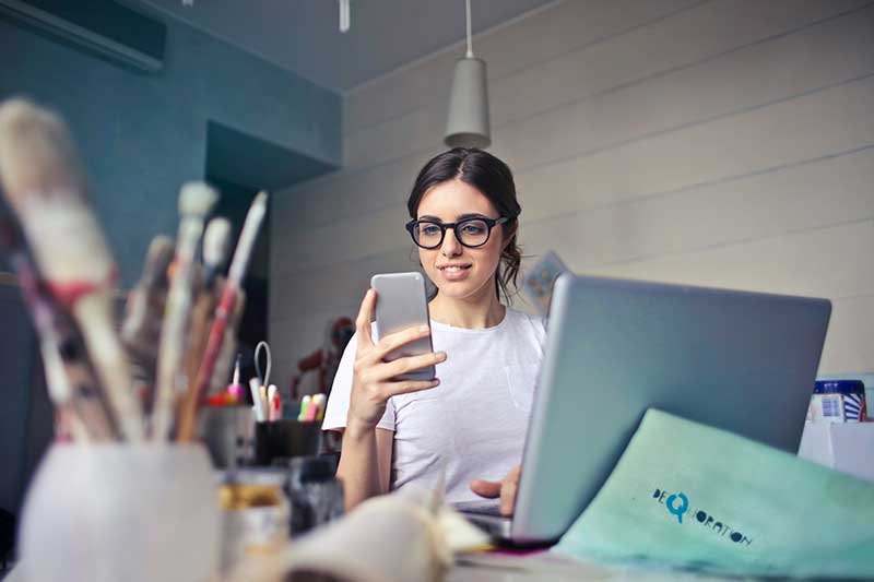 Reviewing documents on a phone and laptop